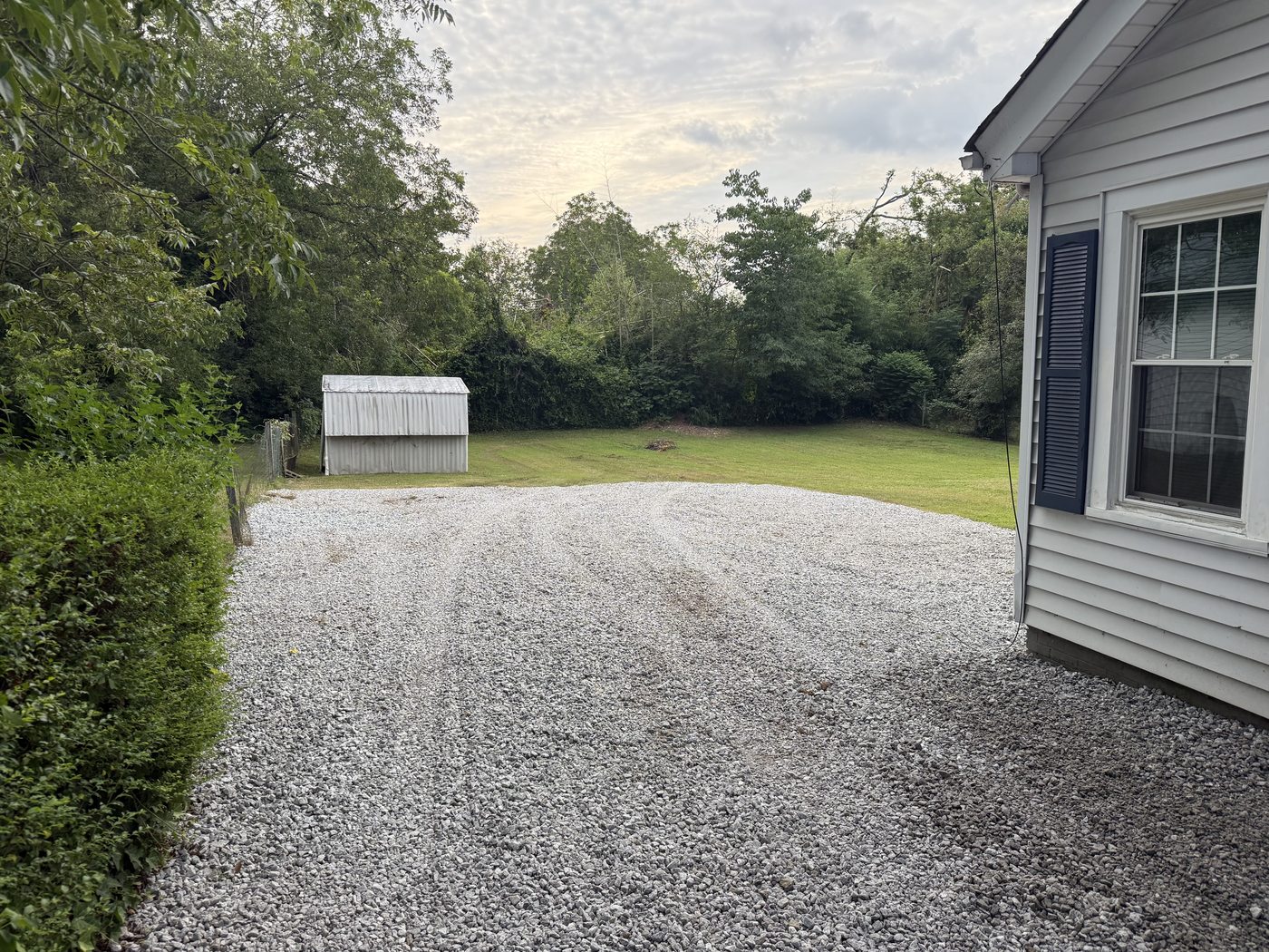 Gravel parking pad installation Greer SC — expanded from small path to two-car pad Iron Lungs