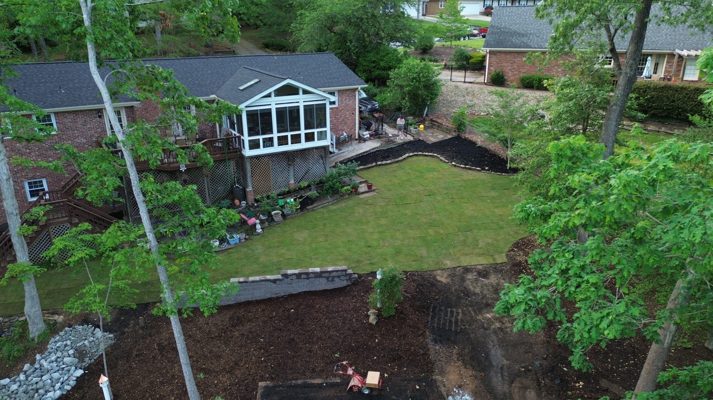After back yard renovation — retaining wall raised garden bed mulch riprap aerial view