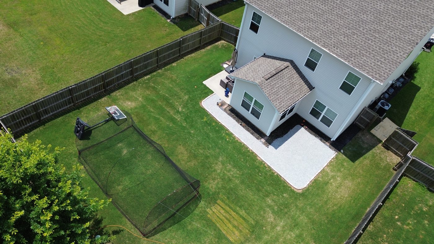 White rock border around new construction home — aerial drone view Greenville SC — Iron Lungs